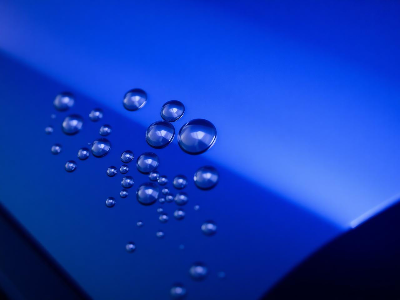 Water beading tightly on a graphene coated dark blue car panel