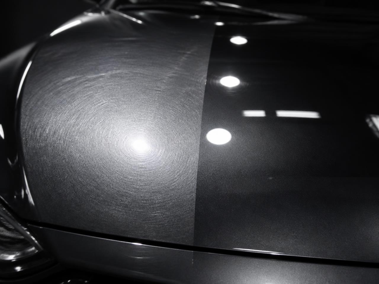 Car bonnet half covered in swirl marks and half polished to a mirror gloss after paint correction